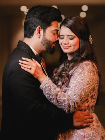 I focus on capturing the connection between a couple. In this intimate shot from their reception, the soft lighting and close framing highlight their quiet affection. It’s a candid moment that feels personal and real, showing the love that is at the heart of the celebration.