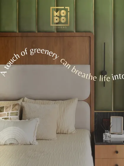 A touch of greenery can breathe life into any space. In this bedroom, the olive green padded wall behind the bed adds texture, color, and a sense of calm.