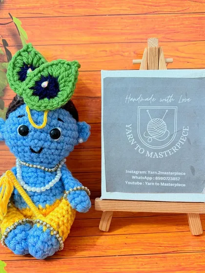 This is my handcrafted Shri Krishna amigurumi doll, a perfect spiritual keepsake. I've carefully crocheted his peacock feather, jewelry, and serene expression using vibrant, child-safe cotton yarn.