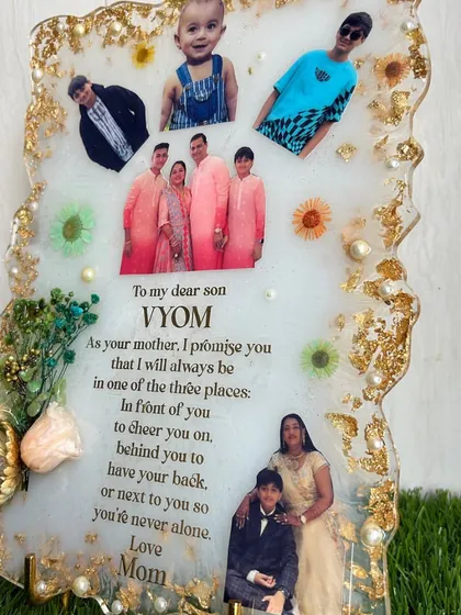 A close-up of the beautiful message on the frame from a mother to her son, surrounded by photos and gold foil.