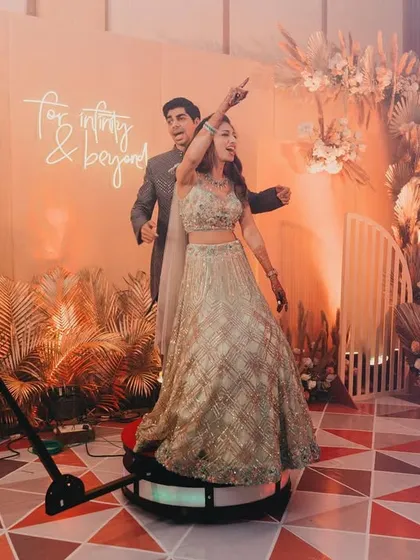 The 360-degree photo booth was a huge hit at this engagement party. The backdrop we designed, with its neon sign and dry floral arrangements, looked amazing from every angle.