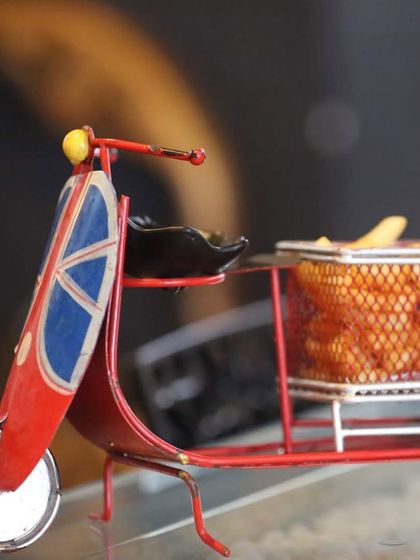 I believe in 'fries before guys', and I like to serve them with a bit of fun. Here are my classic French fries, perfectly seasoned and served in a quirky scooter-shaped holder.