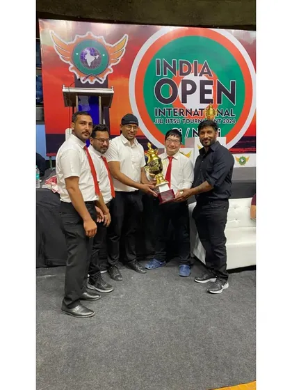 Receiving a team trophy at the India Open International Ju-Jitsu Tournament, recognizing our overall performance.