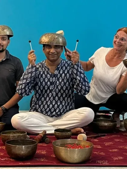 A playful moment from our Sound Healing TTC, with students and a teacher balancing bowls on their heads. Learning should always have an element of joy.