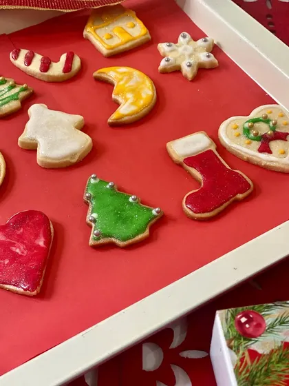 Our Christmas cookie collection is all about festive cheer! This tray features a variety of our hand-decorated holiday cookies, including Christmas trees with silver dragées, classic stockings, shiny candy canes, and delicate snowflakes.