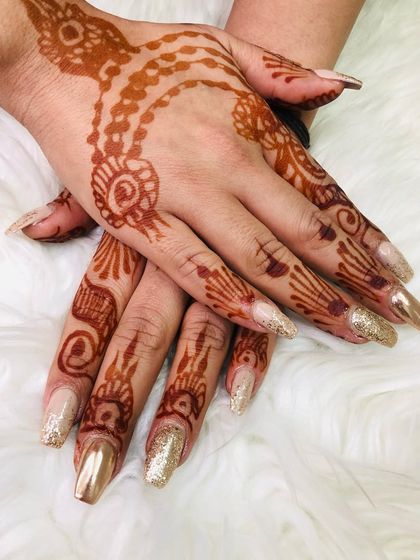 A classic bridal combination of gold and henna. I used a mix of chrome gold and gold glitter polish on these long nails to match the festive feel of her intricate henna design.