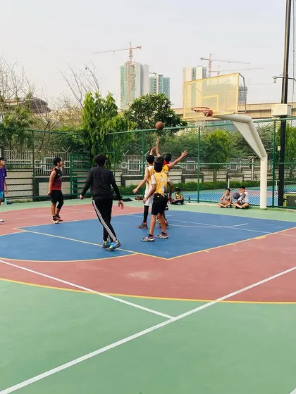 A player attempts a floater in the lane, a useful shot for scoring over taller defenders.