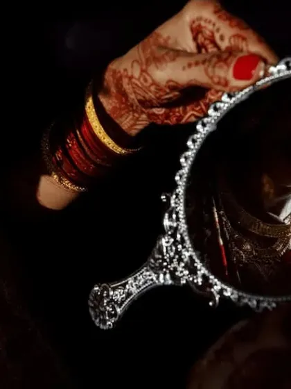 A creative and artistic shot of the bride getting ready. I look for unique angles and lighting to capture the quiet, beautiful moments of anticipation before the main ceremony.
