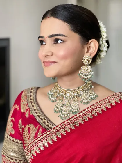 A side profile showing the soft, natural-looking makeup and the beautiful gajra in her hair. It's a look of pure, simple elegance.