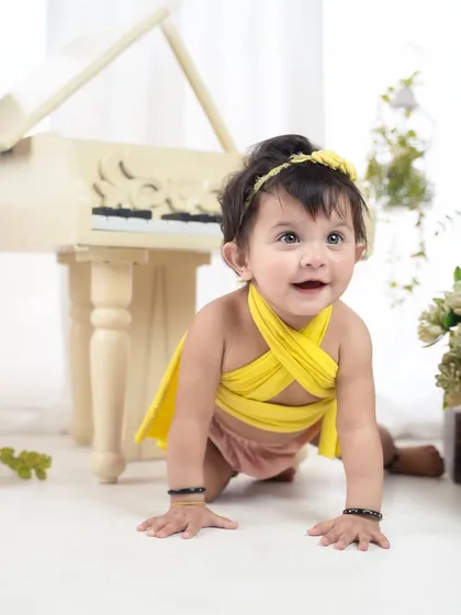 A happy crawl towards the camera. This little one is full of energy and smiles during her colorful first birthday session.