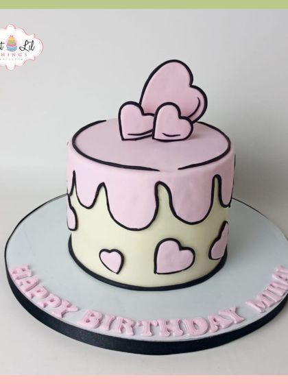 A cute and trendy cartoon-style cake. This minimalist pink and white heart-themed cake looks like it's straight out of a comic book.