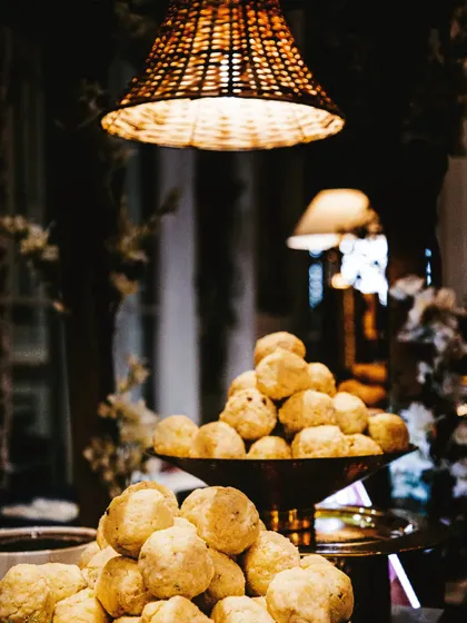 Soft, spongy Dahi Bhallas piled high in a rustic bowl. This classic dish is a cooling and delicious addition to any wedding menu, especially during warmer months.