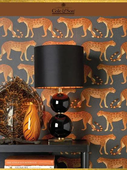 The 'Leopard Walk' wallpaper from Cole & Son adds a touch of the wild to this sophisticated space. The repeating pattern brings a rhythmic energy, creating a design that is both playful and elegant.