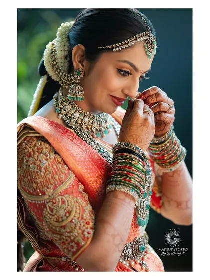 A candid moment as Likitha adjusts her nose ring. It is these small, beautiful moments that make a wedding so special. Her makeup is designed to look flawless even in unposed, natural shots.