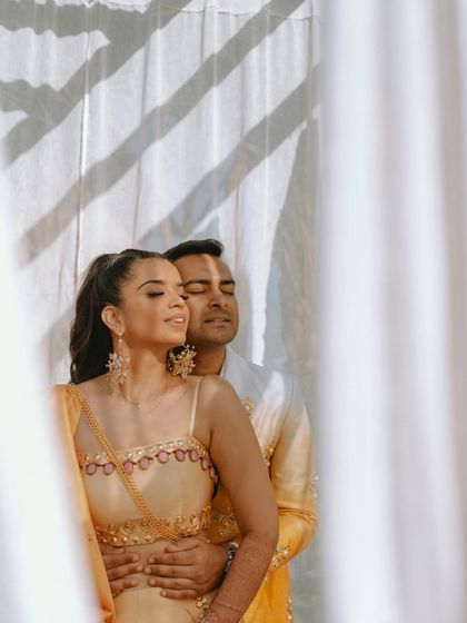 A beautiful portrait of the couple with their eyes closed, basking in the sunlight and their love for each other.