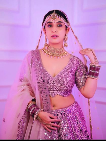 This lilac lehenga with mirror work detailing is a trendy and chic option for a sangeet or reception. The color is modern and photographs beautifully.