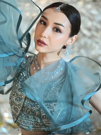A close-up on the stunning details of the blouse and the ruffled sleeves. This is the kind of unique piece that makes a portfolio stand out.