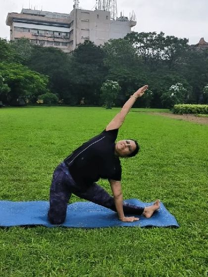 This is Parighasana, or the Gate Pose, which I often recommend for relieving back pain. Practiced here in a park, this pose provides a deep side-body stretch, releasing tension in the spine and improving flexibility. Nature and yoga are a perfect combination for healing.