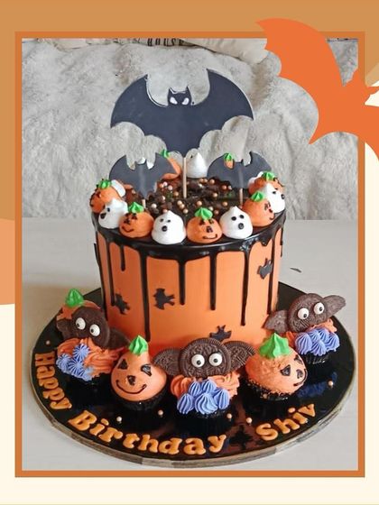 A fun Halloween birthday cake with a bat topper, ghost and pumpkin cake pops, and bat-shaped Oreos.