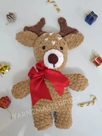 The plush Christmas reindeer, surrounded by festive ornaments.