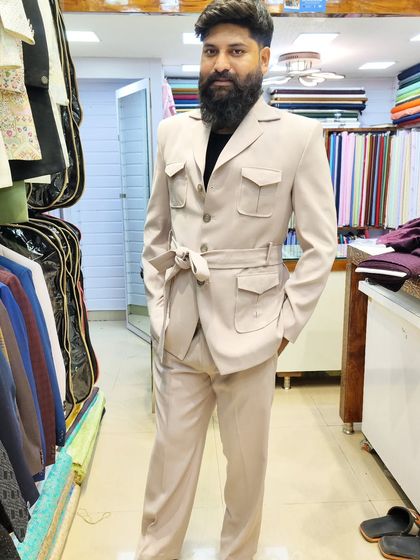 More examples of our unique tailored pieces, including different colors and styles of safari suits and blazers for clients seeking a distinctive wardrobe.