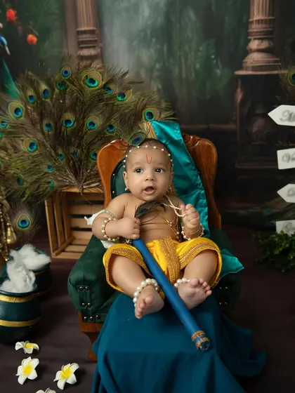 A curious little Krishna looks up in wonder. The dramatic lighting and rich colors of this set create a truly magical portrait.