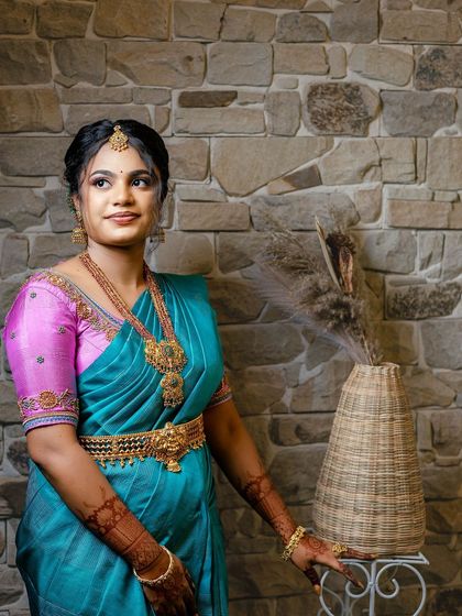 Sugirtha posing elegantly. Her makeup enhances her features, and the entire look is a perfect blend of traditional and modern styles.