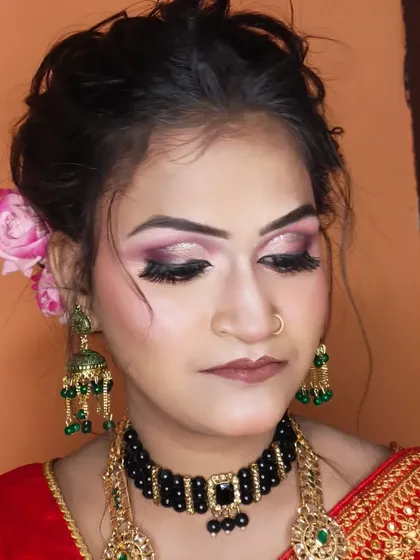 A detailed close-up of the eye makeup, featuring a soft cut-crease with pink and brown shades.