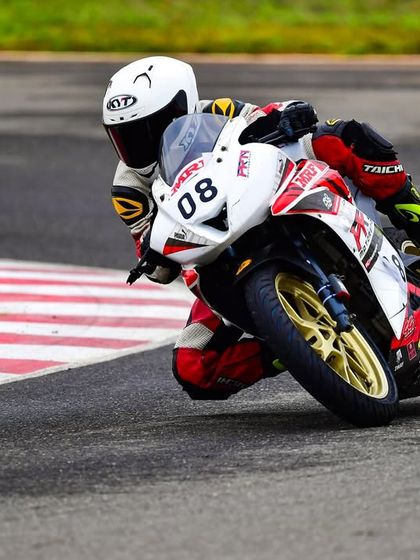 Meghana in action during her INMRC debut. This shot captures her focus and determination as she navigates a corner in the Stock 130-165cc Girls category.