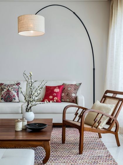A closer look at the seating in the Terrazzo Residence, where a classic wooden chair with cane detailing sits beside a contemporary sofa. This mix of styles creates a layered and timeless interior.
