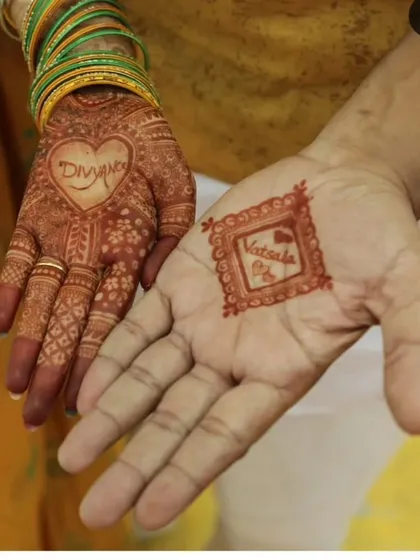 A personalized design for a bride and groom, featuring their names inside hearts. This is a simple yet very popular way to customize your mehendi.