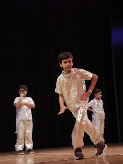 This dancer shows off a cool, stylized move, highlighting the modern and hip-hop dance styles we teach in our junior batches.