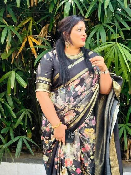 Another view of the client in her black floral saree, showing how the light and airy fabric moves.