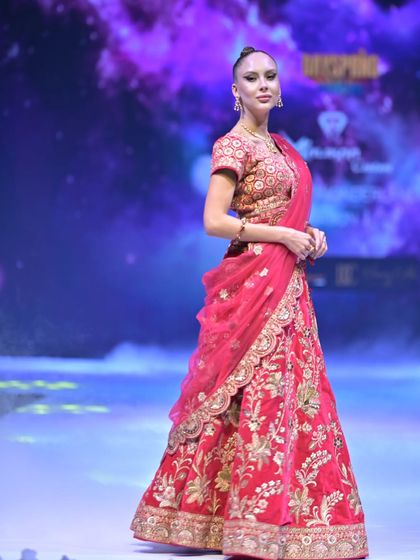 A classic red bridal lehenga, rich with intricate gold floral embroidery. I designed this for the bride who wants a timeless, regal look that honors our beautiful traditions.