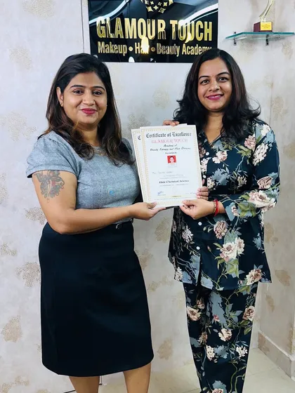 Presenting a Certificate of Excellence to a dedicated student. Our certification is a mark of professional skill and dedication.
