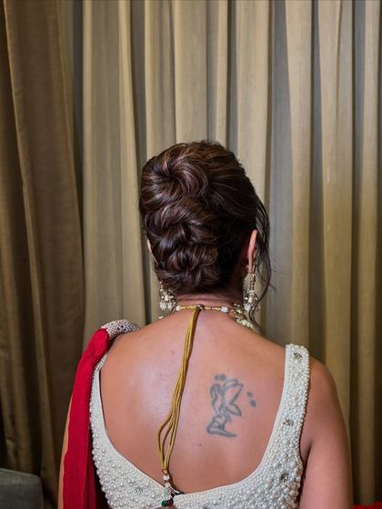 A high, textured bun with beautiful highlights woven through. The height of the bun adds a touch of drama and sophistication.