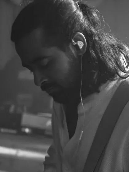 A quiet, focused moment for our guitarist amidst the noise. It shows the dedication and craft that goes into every performance.