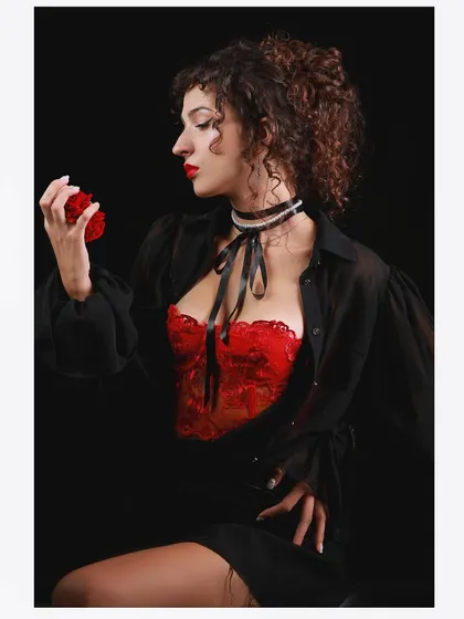 Another shot from the vintage series, with the model holding a red flower prop to enhance the romantic, classic theme.