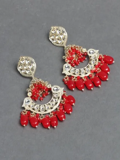 These vibrant red kundan chandbalis are hand-fixed with beads and are surprisingly lightweight. They are perfect for the festive season and can be customized.