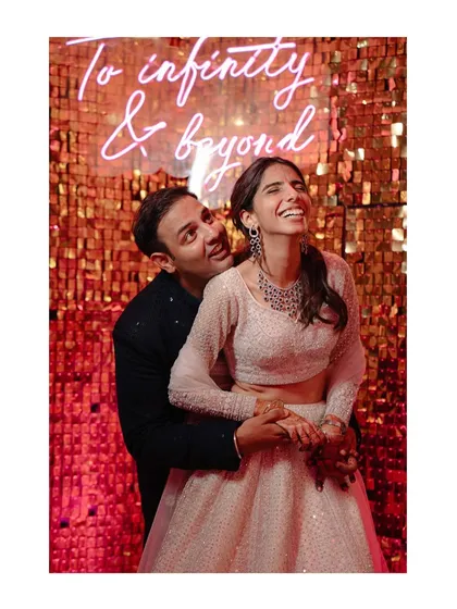 We love the pure, uninhibited joy of a wedding celebration. This moment with Shraddha and Mandela, laughing under a neon sign that says it all, perfectly captures the fun, modern, and slightly mad energy we love to document.