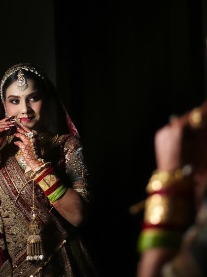 My bride Bharti, looking at her reflection. It's that final moment of seeing yourself as a bride before you walk out.