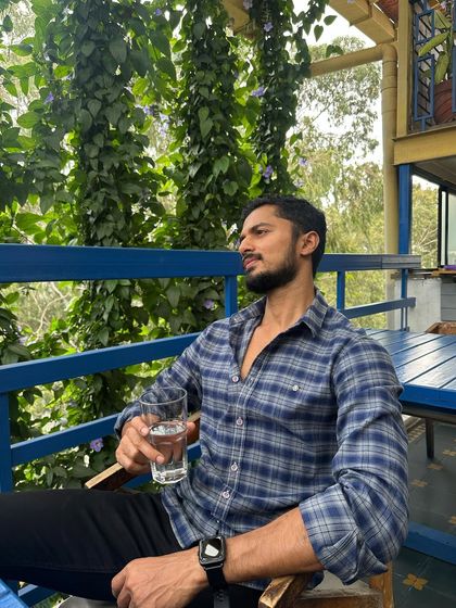A moment of relaxation with a glass of water, enjoying a peaceful view.