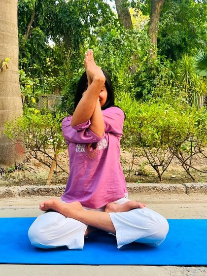 Practicing Garudasana (Eagle Pose) arms while seated in Padmasana. This variation is great for opening up the shoulders and upper back.