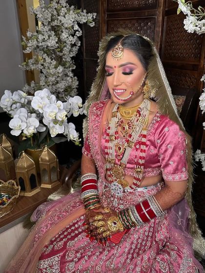 Our beautiful bride Anjali, glowing on her wedding day. We chose a vibrant pink theme for her makeup to match her stunning lehenga, complete with a beautiful nath and maang tikka.