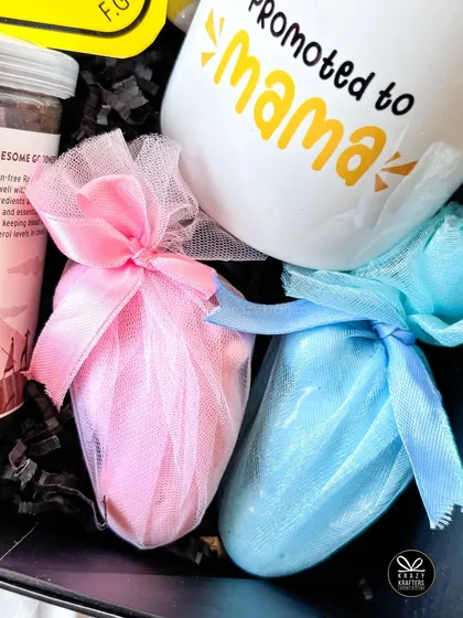 These pink and blue net-wrapped goodies add a hint of gender-reveal mystery to a pregnancy announcement hamper.