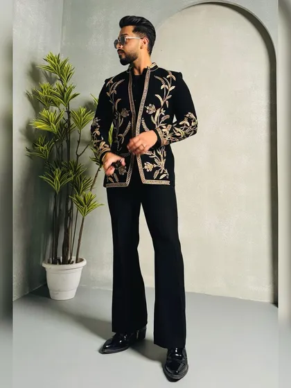 This client steals the show in a black velvet jacket with stunning gold floral embroidery. Paired with flared trousers, it's a fashion-forward look for any high-profile event.