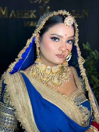 A direct, confident shot of the bride. The makeup is bold yet elegant, a signature style I teach.