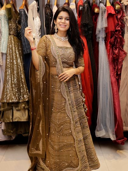 A full-length view of the beautiful mehendi-green lehenga, showing its elegant flow and intricate work.
