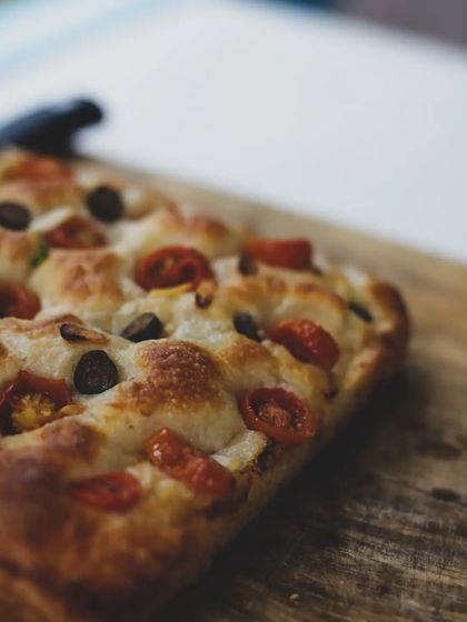 A classic focaccia bread with tomatoes and olives. A versatile Italian bread that's fun to make and delicious to eat.