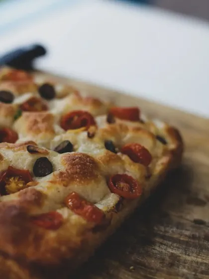 The rich, golden-brown crust of a freshly baked focaccia.